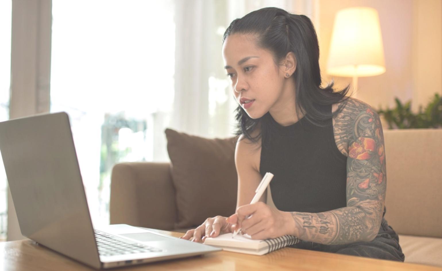 Students collaborating on NLP project with code displayed on multiple screens